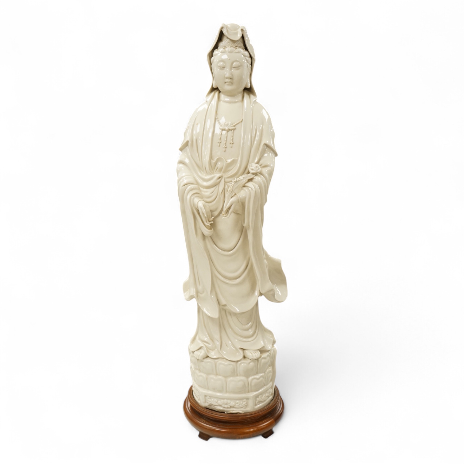 A Chinese blanc de chine figure of Guanyin, on stand, 81cm high